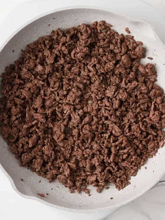 Ground beef browned in a skillet for hamburger casserole.