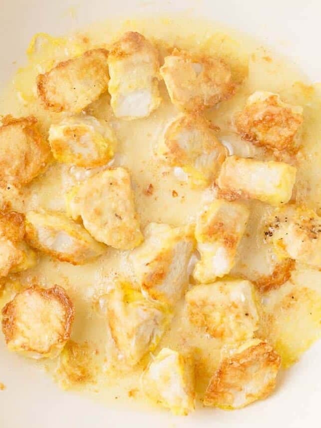 Frying chicken pieces.
