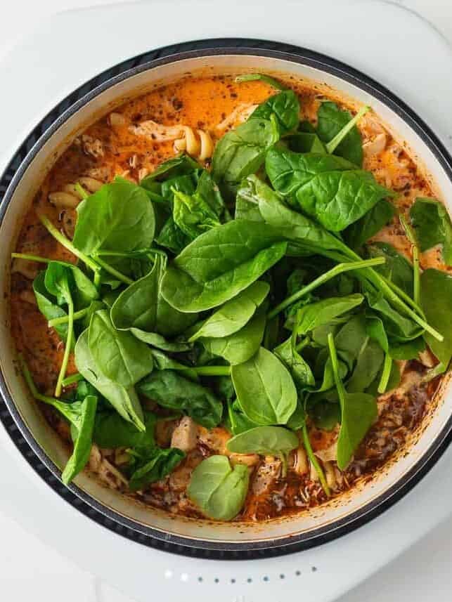 Fresh spinach added to the pot of soup before serving.