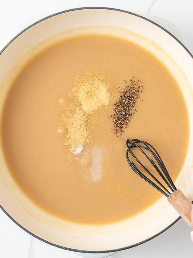 Brown gravy seasoned with garlic powder, onion powder, salt and pepper in a large skillet.