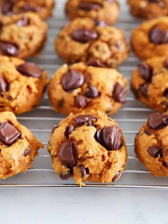 Pumpkin cookies with cake mix resting on a bakers rack.