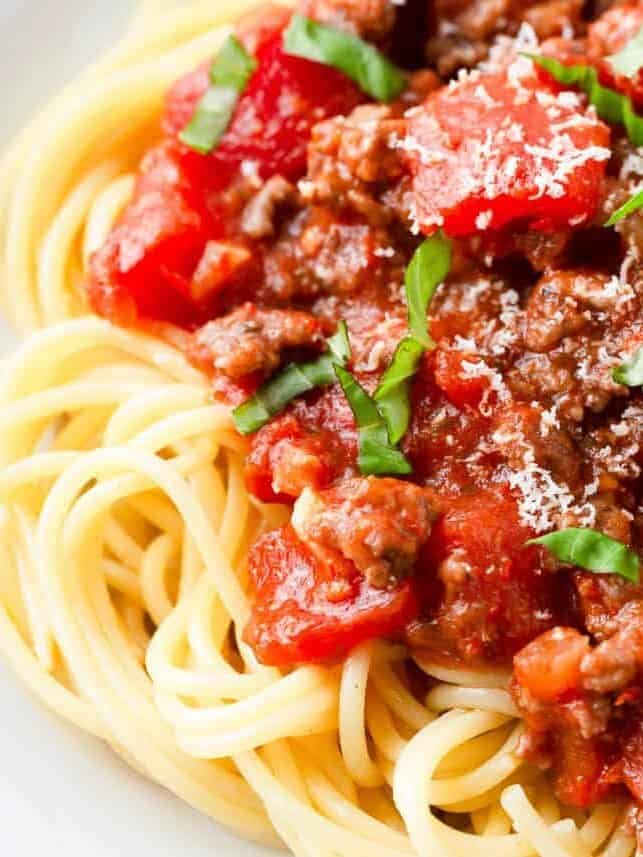 Spaghetti topped with homemade meat sauce, fresh basil, and parmesan cheese.