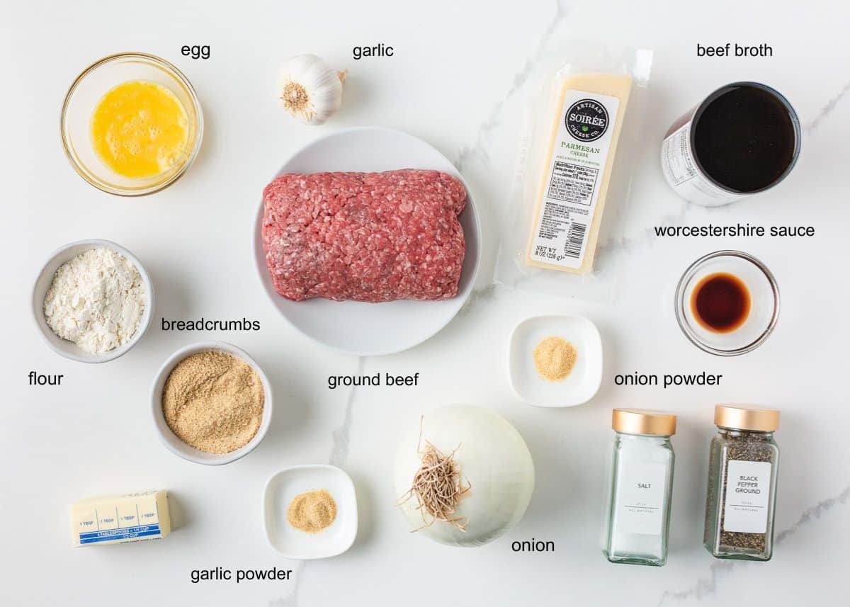 Ingredients for homemade meatballs and gravy including ground beef, egg, breadcrumbs, Parmesan, onion, garlic, beef broth, butter, flour and seasonings.