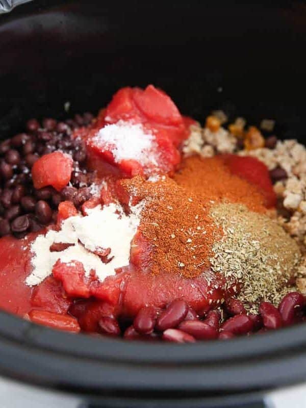 Beans, tomatoes and chili seasonings added to browned ground turkey in the pot.