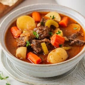 Bowl of chuck roast beef stew with tender beef, potatoes, carrots and celery.