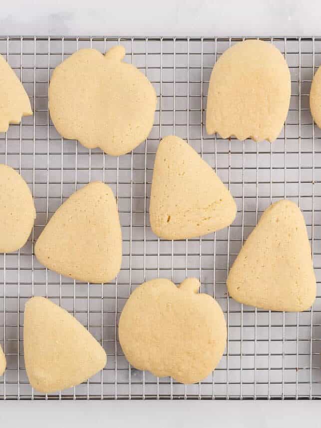 Halloween sugar cookies on cooling rack.