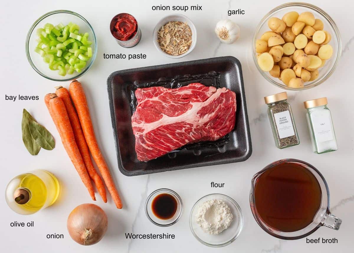 Chuck roast beef stew ingredients with beef, potatoes, carrots, celery, onion and seasonings.