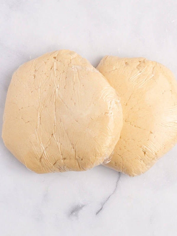 Sugar cookie dough wrapped in plastic before chilling.