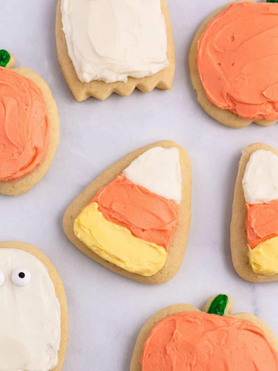 Frosted Halloween sugar cookies decorated as ghosts, pumpkins, and candy corn.