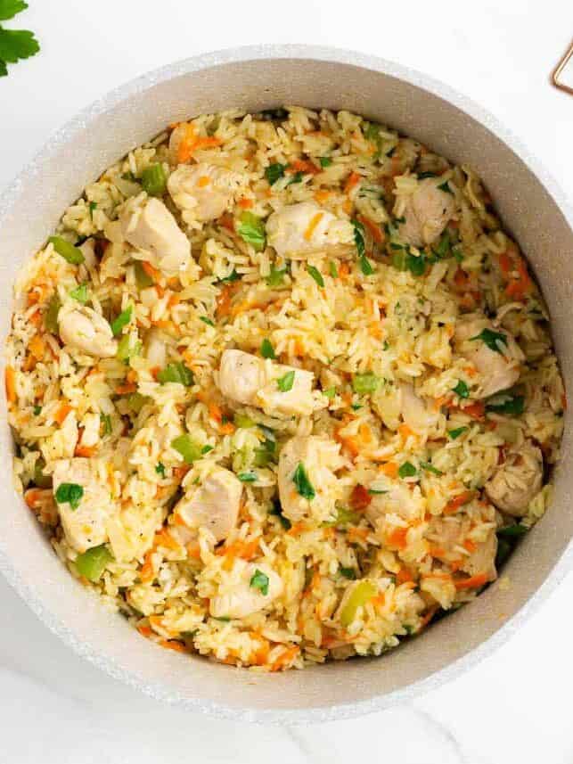 Finished one pot chicken and rice garnished with fresh parsley in the pot.