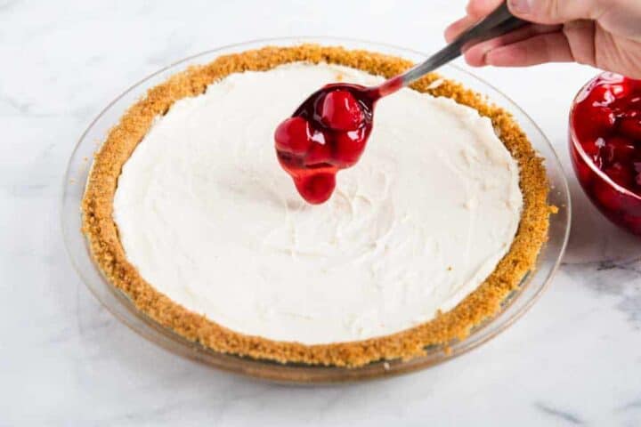 This no-bake cheesecake recipe is perfect for beginners! Only 5 ingredients and absolutely no baking. It's everything a cheesecake should be...silky, smooth, light, creamy and decadent! adding cherry filling on top of no bake cheesecake