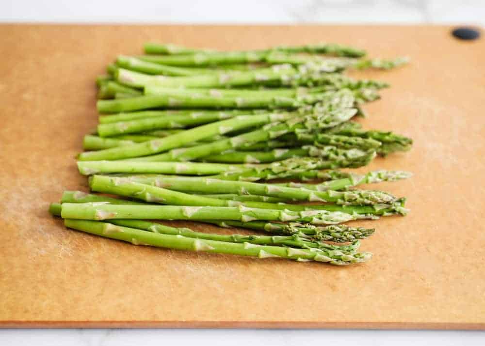 Asparagus spears on a cutting board.