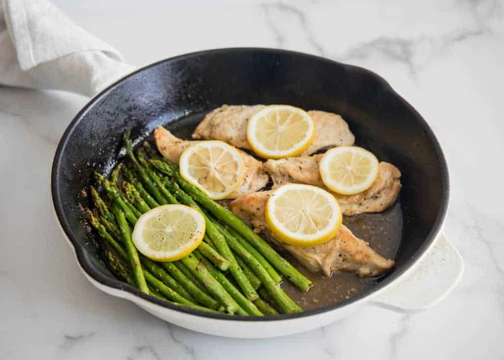 Tender baked lemon chicken coated in a flavorful lemon butter sauce. An easy 30-minute meal that requires only 7 simple ingredients! lemon chicken in skillet