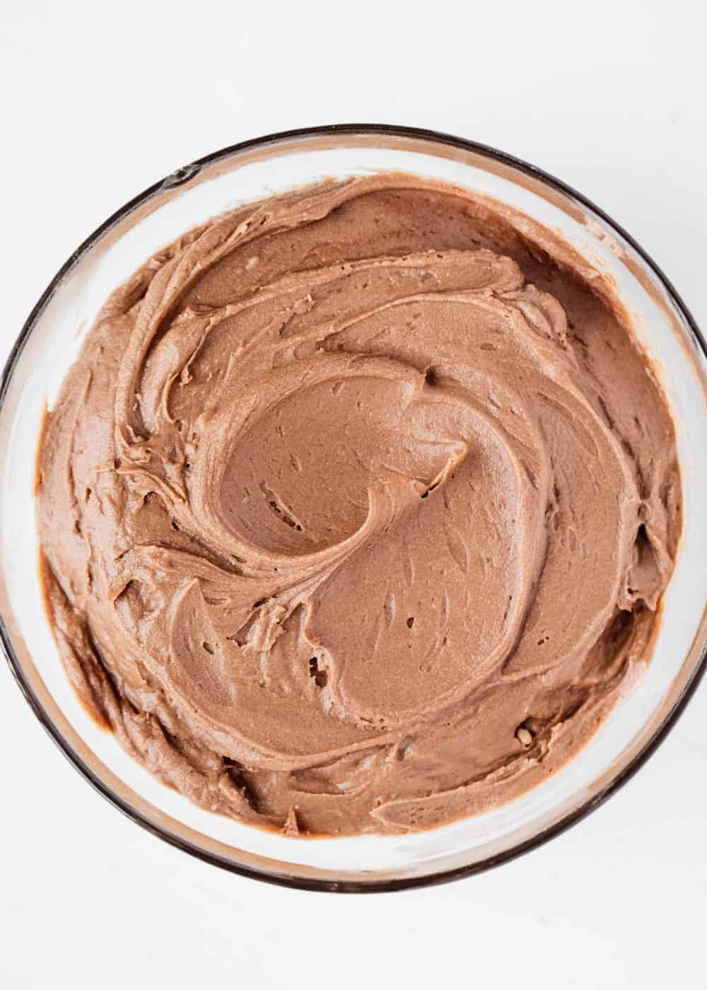 Chocolate cream cheese frosting in a glass bowl.