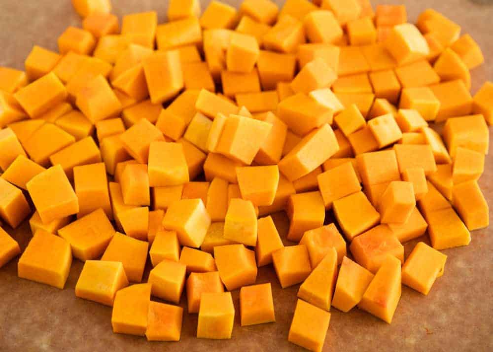 Cubed butternut squash on a cutting board.